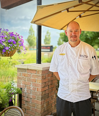 Marcella's Polaris Executive Chef Michael Coleman standing on the outdoor patio.